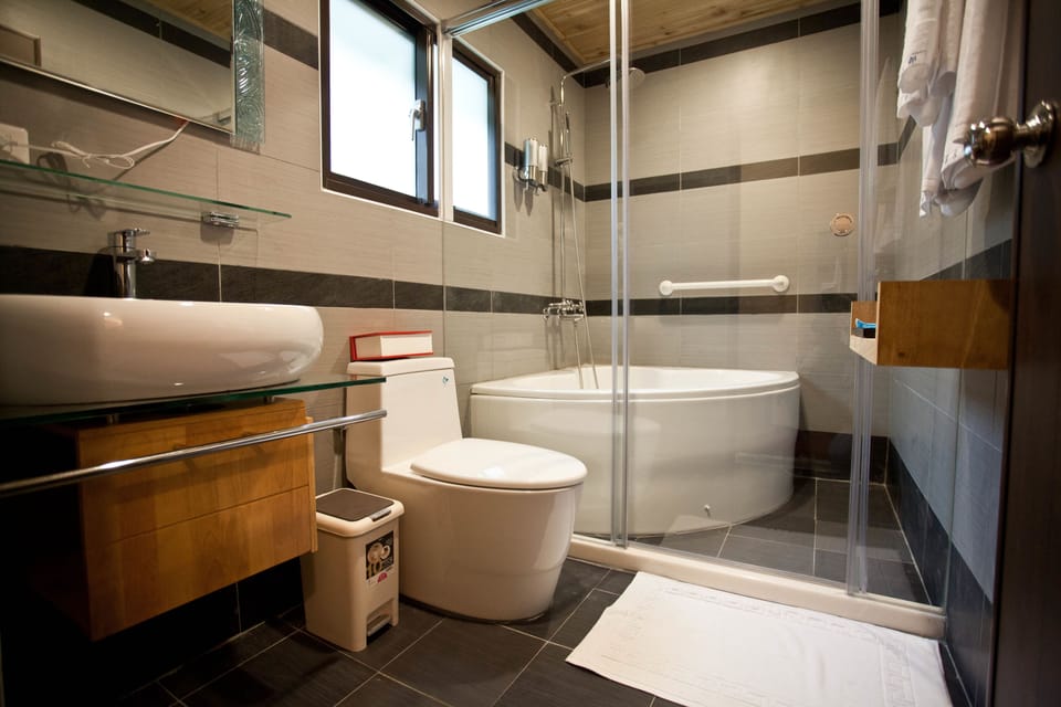 Classic Suite | Bathroom | Rainfall showerhead, hair dryer, electronic bidet, towels