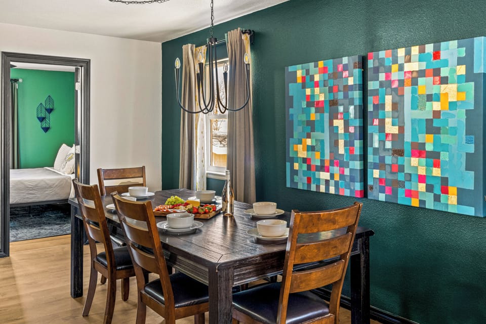 The dining area features deep green hues and sophisticated details for a refined experience.