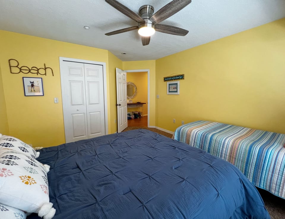 Guest bedroom with a queen bed and a twin bed. - Guest bedroom with a queen bed and a twin bed.