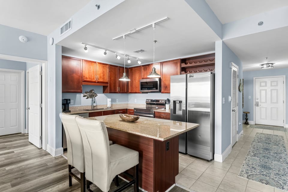 Modern kitchen with granite island and stainless steel appliances