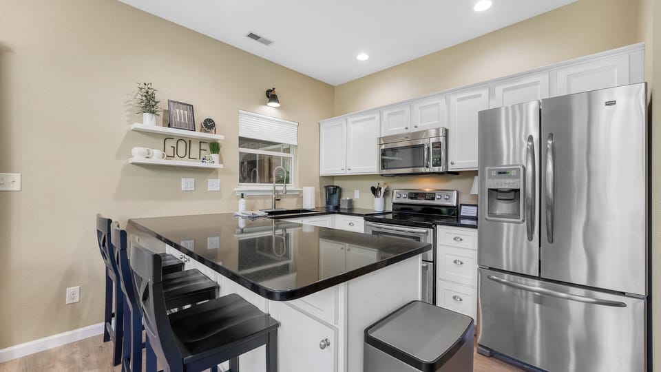 Well appointed kitchen area with bar seating, new appliances and an open view