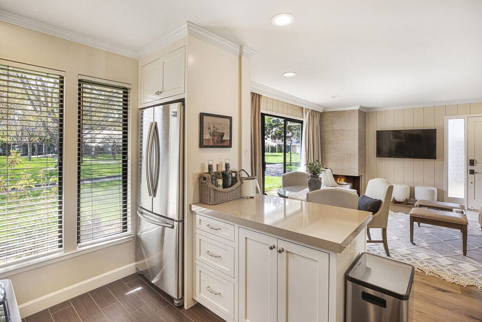 Enjoy an open flow from the kitchen to the living space, where bright windows and green views make every morning feel fresh and relaxing.