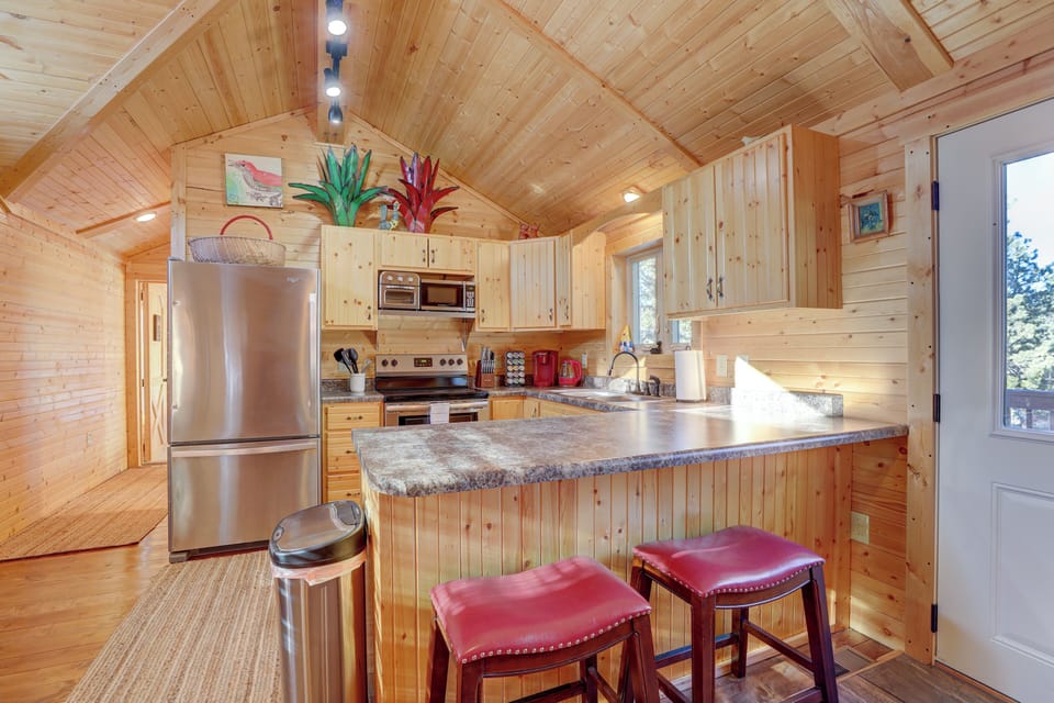 The full kitchen features everything for meals plus a breakfast bar for dining.