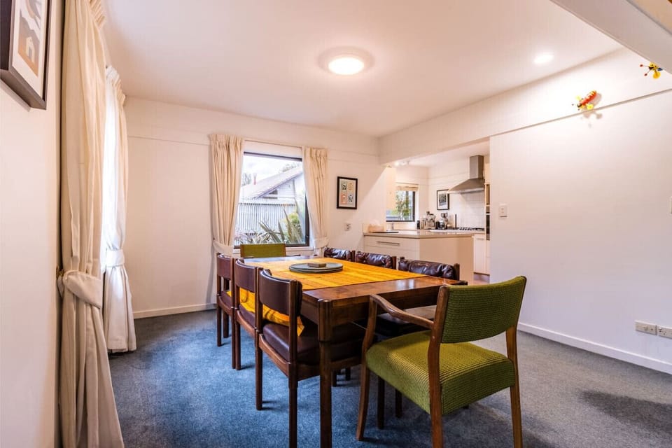 Our retro dining area features a stunning rosewood table that’s perfect for everything from brekkie to board games. It flows right into the kitchen, making it easy to serve up meals, share stories, or linger over a wine.