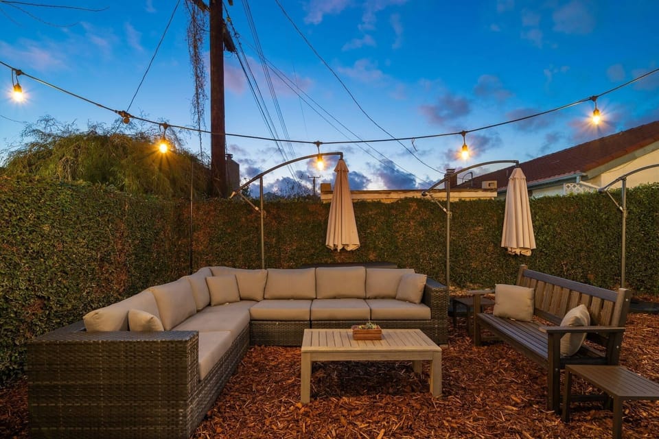 Enjoy the afternoon poolside in our private fenced-in yard in this quiet neighborhood. Our L-shaped sofa fits 4-6 comfortably, or lie down for a nap while the sun sets. Truly a turnkey experience. Weekly pool service included. 