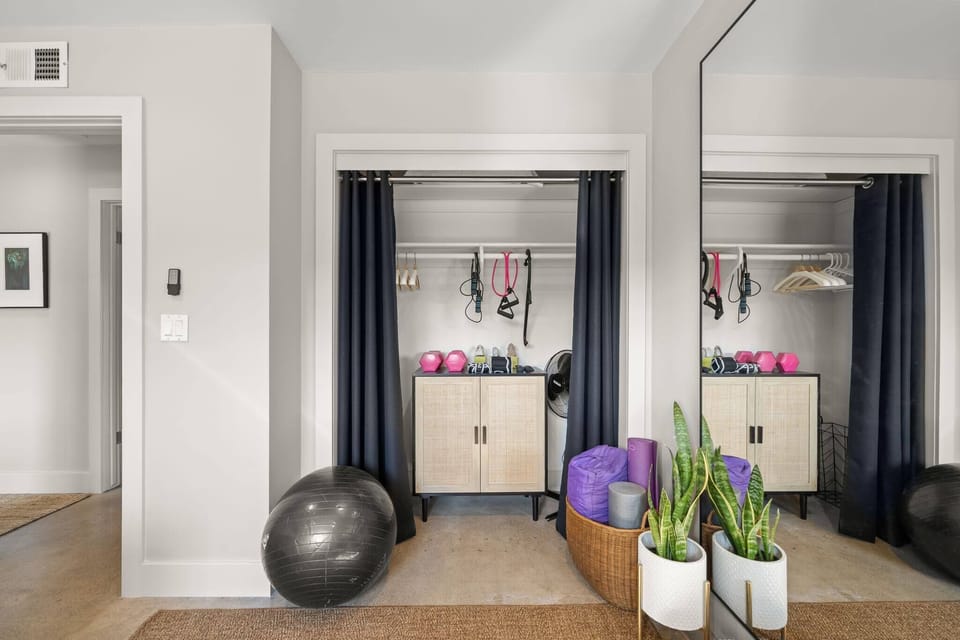 Stay active with this thoughtfully arranged workout area complete with a yoga mat, pilates ball, hand weights, jump rope, stretching bands, foam roller and body back buddy. This house is nestled between 4 outdoor areas, designed for fitness.