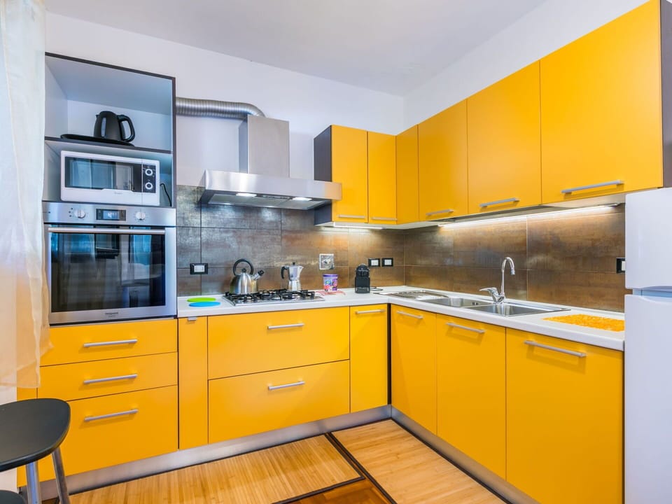 Kitchen, Kitchen Appliance, Major Appliance, Countertop, Cabinetry, Yellow, Interior Design, Flooring, Kitchen Stove, Floor