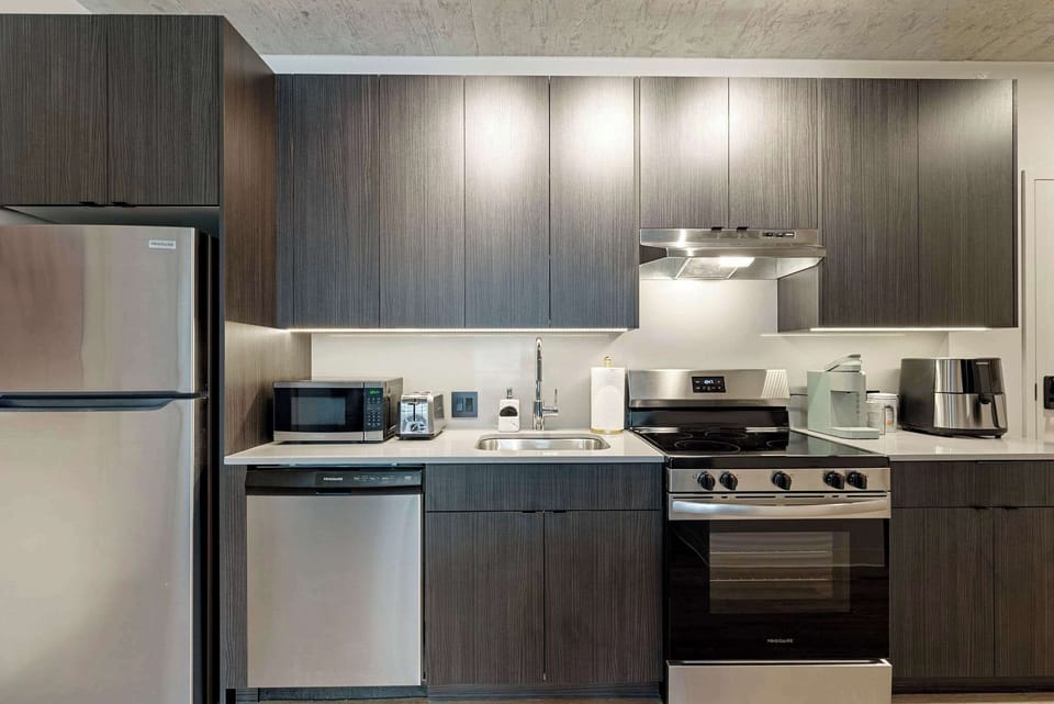 Sleek kitchen counters offer plenty of space to prep, plate, and enjoy home-cooked favorites.