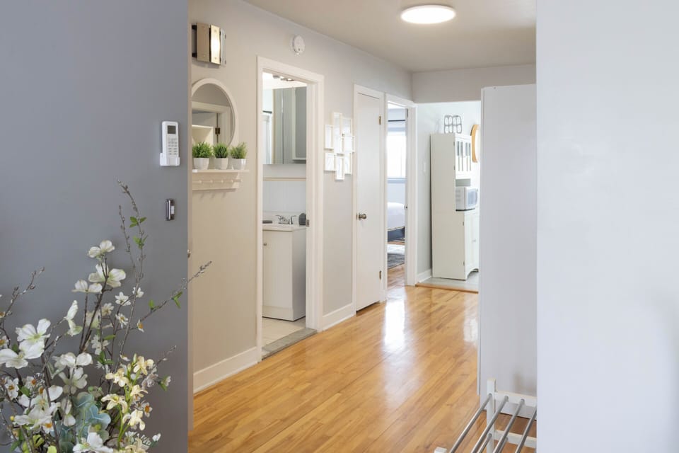 A bright and inviting hallway with warm wood floors and charming decor awaits!