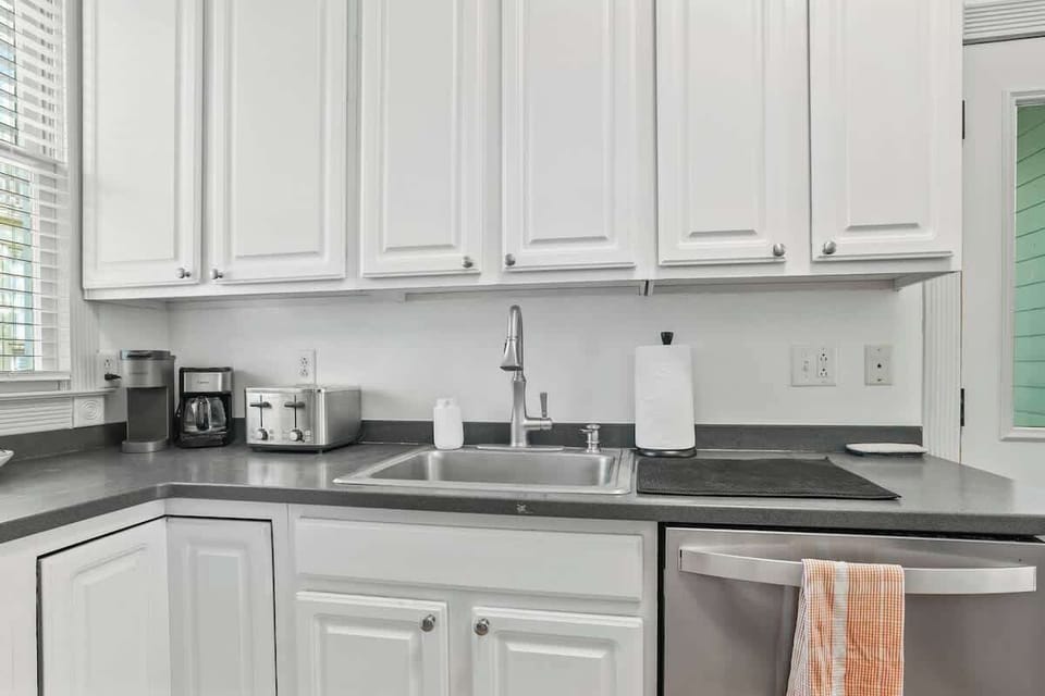 Sleek and clean - Our corner kitchen is well organized and stocked with everything you need, just an arm's reach away.