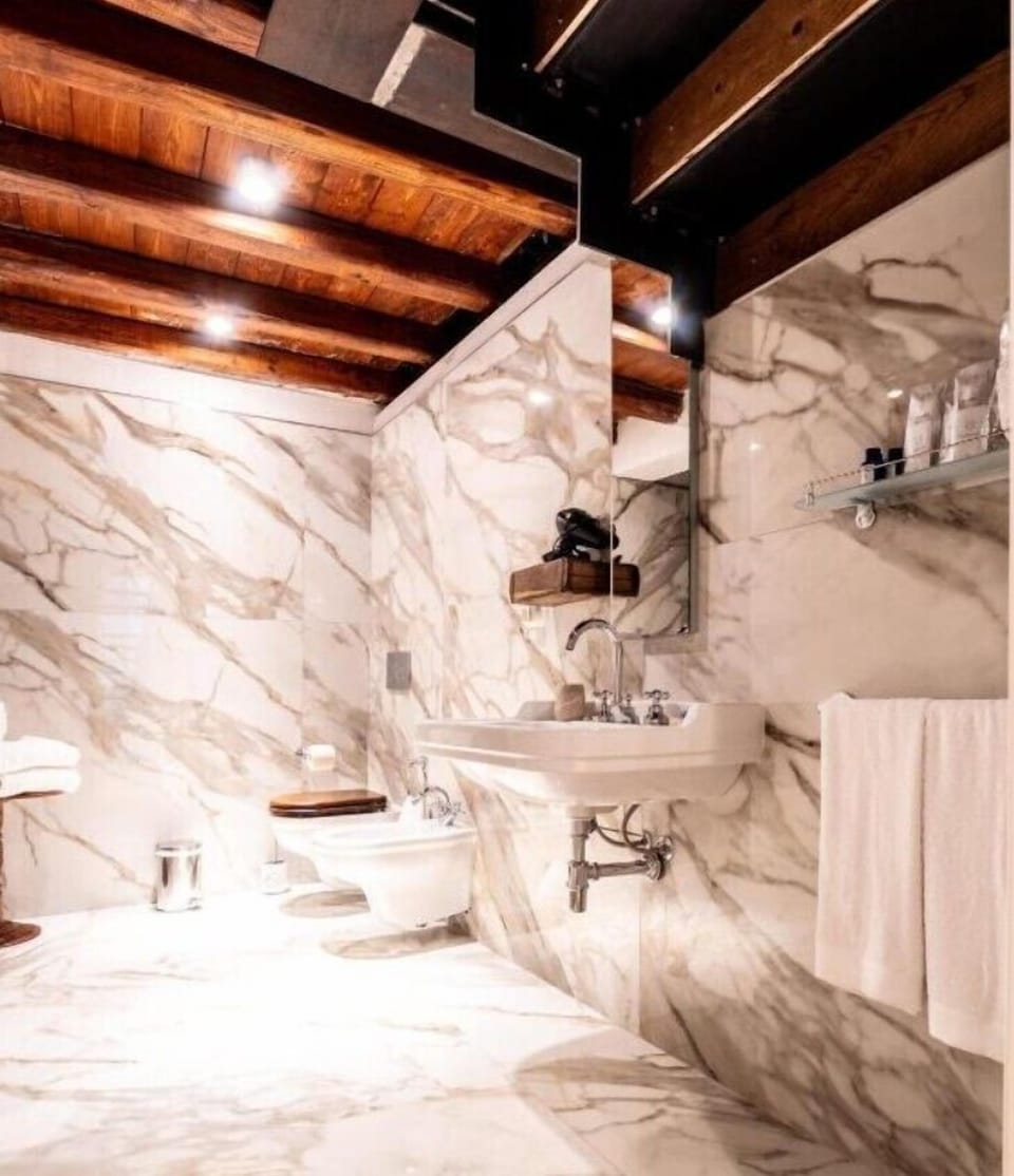 Luxury Studio Suite, Balcony, City View | Bathroom | Free toiletries, hair dryer, slippers, towels