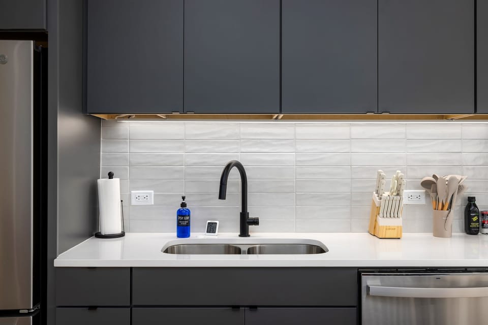 Attention to detail—the kitchen sink area is designed with sleek, modern fixtures, blending function and aesthetics seamlessly.