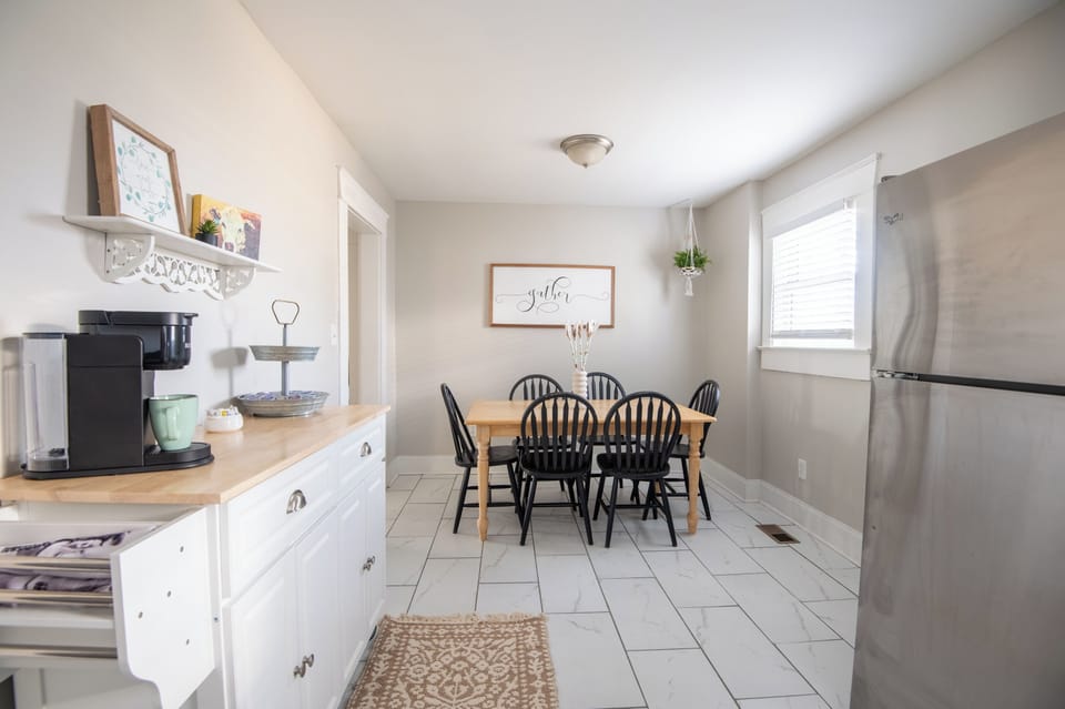 Open and welcoming dining area leading into a fully equipped kitchen