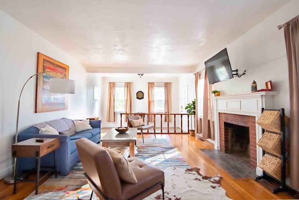 Step into relaxation with this inviting living room, boasting a plush sofa facing a large flat-screen TV, perfect for movie nights.  Message us about our concierge services and locally curated experiences.