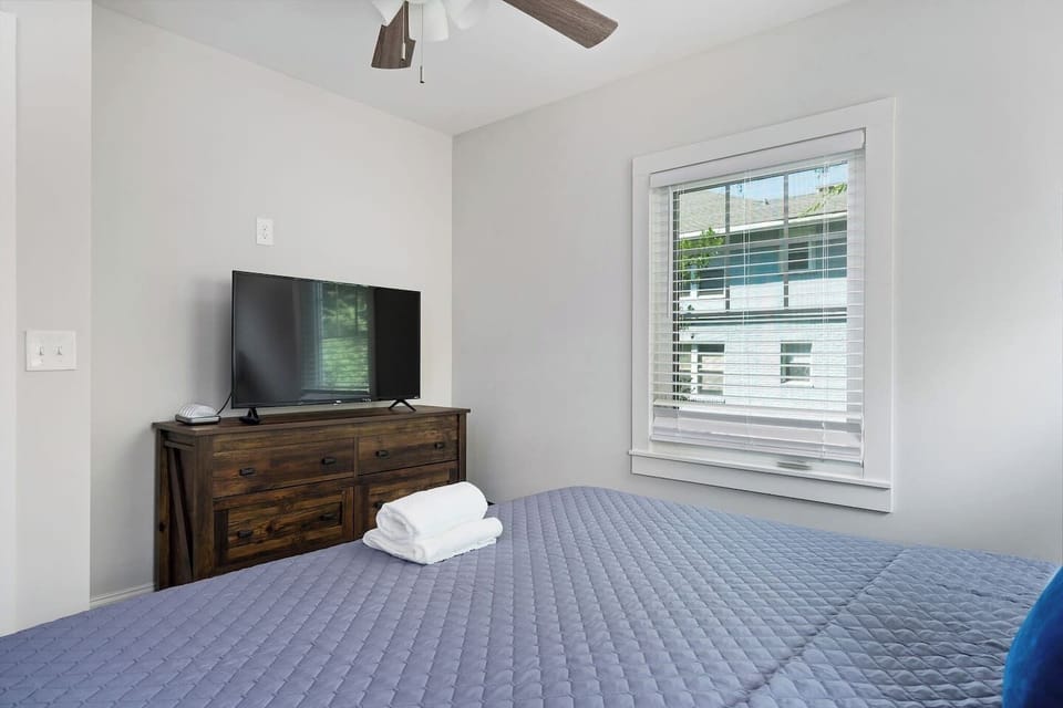 This cozy bedroom offers a large bed, soft lighting, and tranquil decor, ensuring a restful environment.