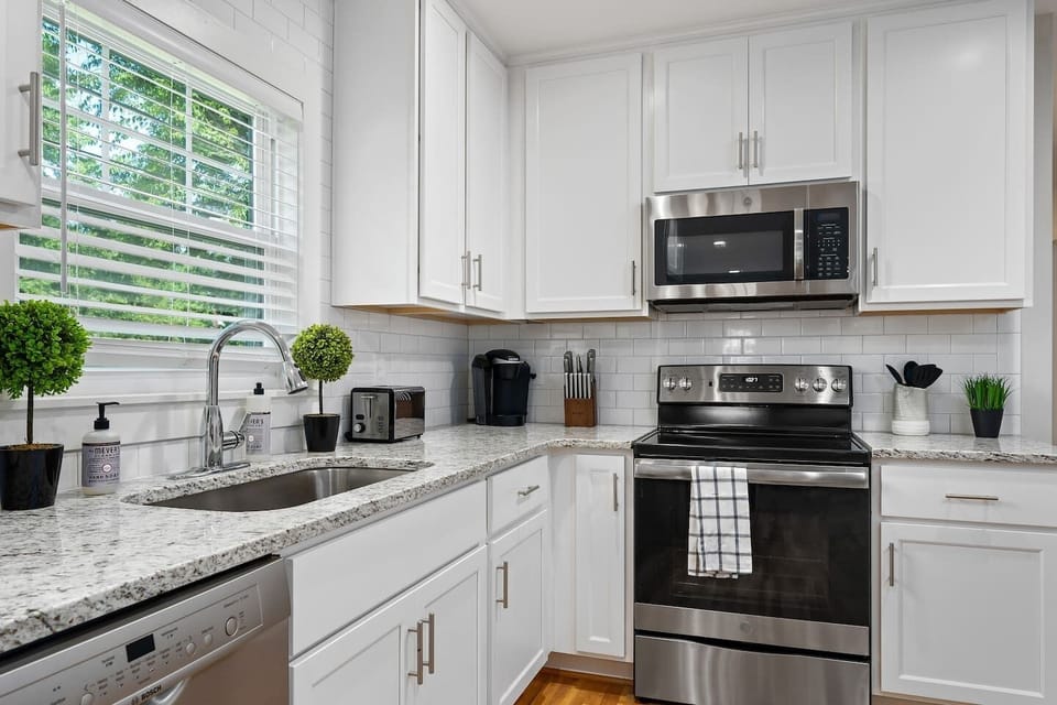 A modern kitchen equipped with stainless steel appliances, ample cabinetry, and a large island, ideal for meal preparation and casual dining.