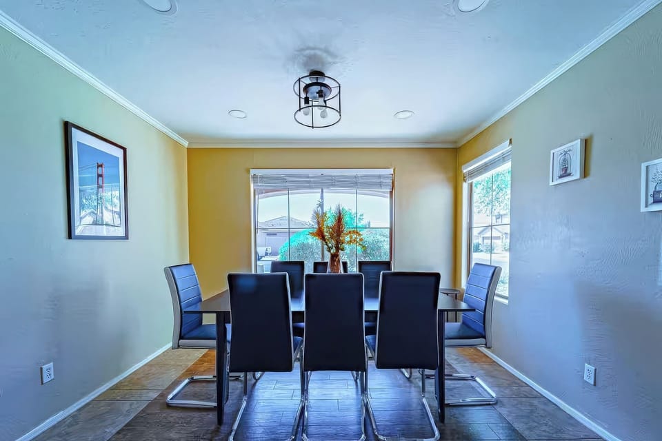 Sunny dining room with modern seating for six and garden views.