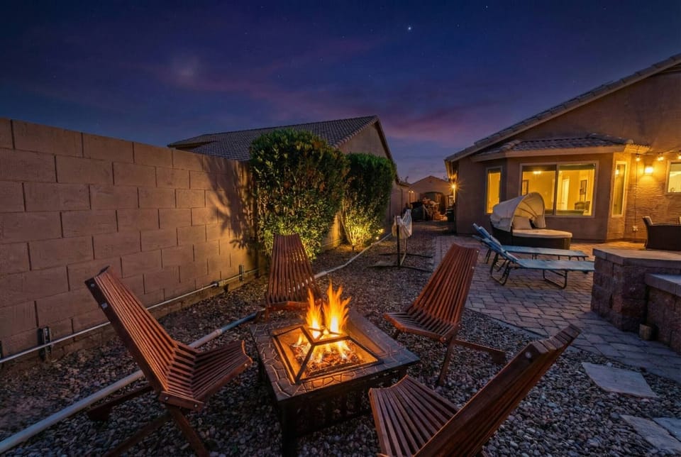Cozy backyard retreat with fire pit, loungers & twinkle lights