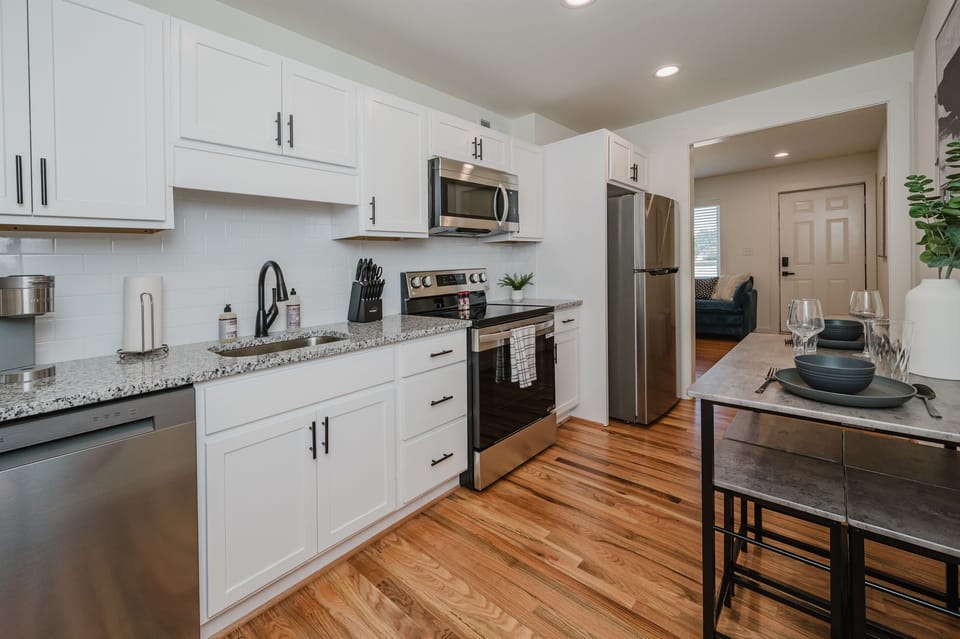 Contemporary kitchen setup with bar seating for casual meals or morning coffee.