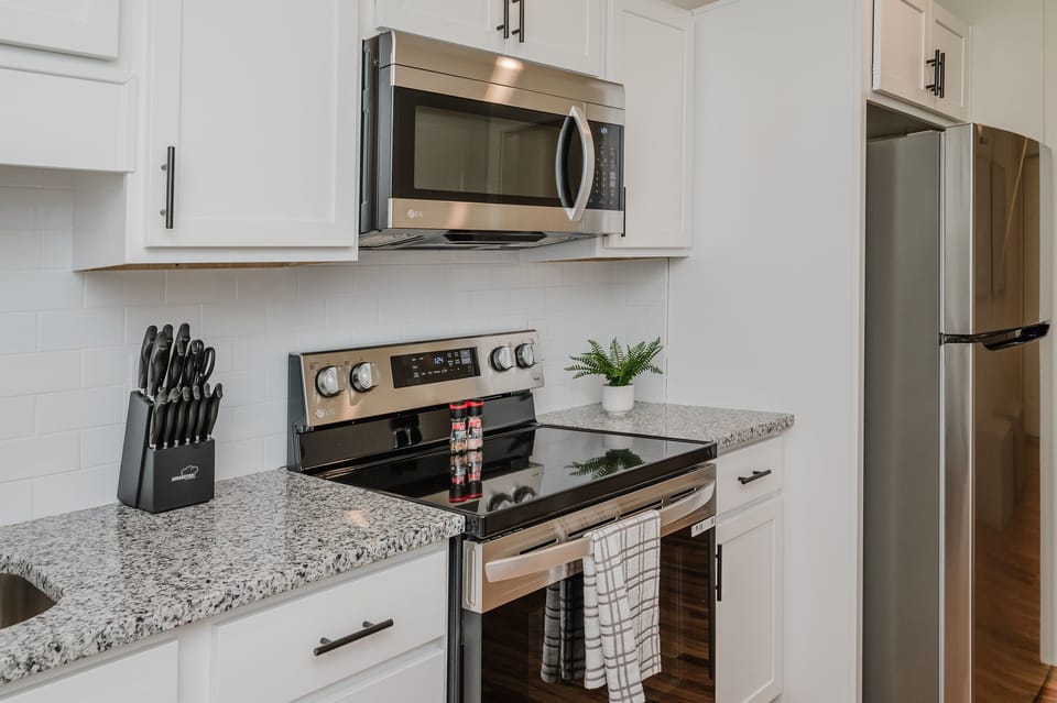 Fully equipped kitchen featuring modern appliances and ample storage.
