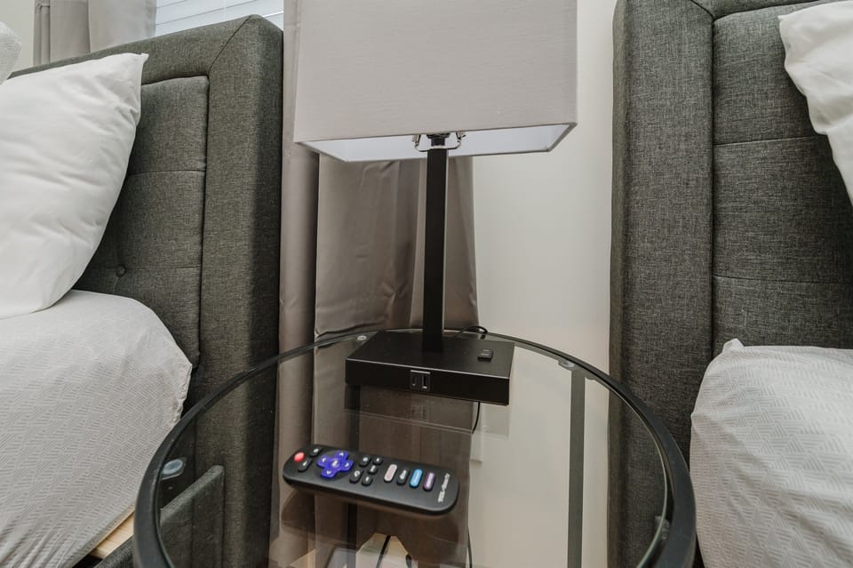 Sleek bedside table equipped with a lamp and essential storage, perfect for keeping your nighttime essentials within reach.