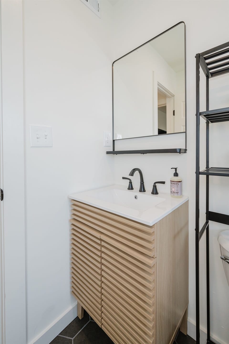 Modern bathroom vanity featuring ample storage and a large mirror, perfect for your morning and evening routines.