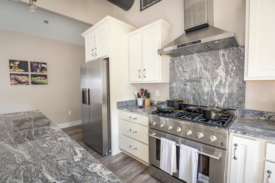 Fully equipped kitchen with utensils, pots, pans, and a convenient pot filler.