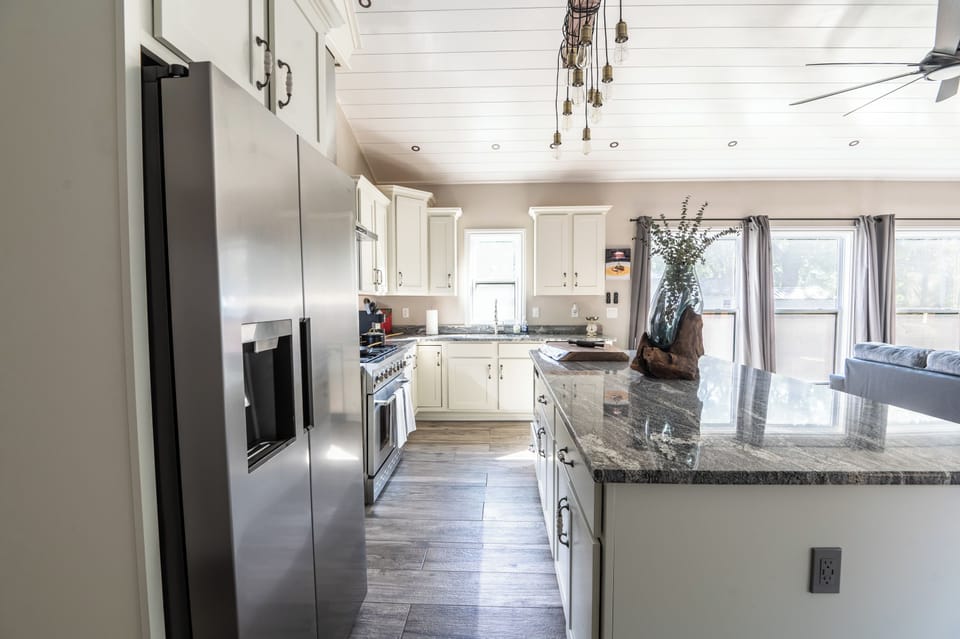 Modern kitchen with brand new appliances and a large island. Add a luxury experience with LegacyStays.org!