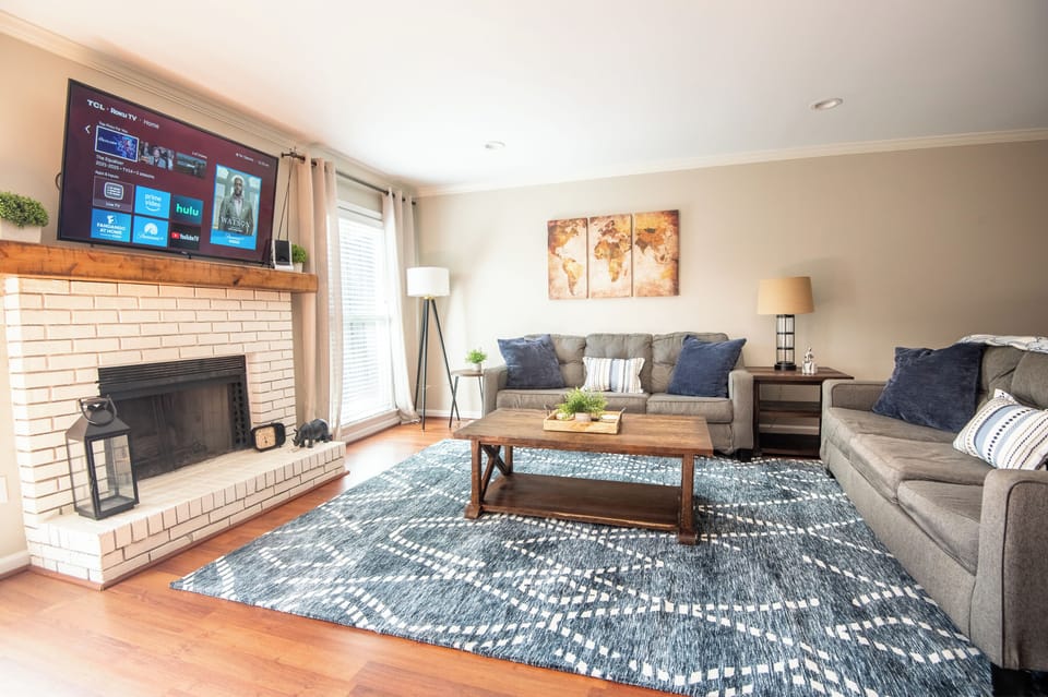 Welcome to Homewood Heights – where cozy elegance meets modern comfort! Relax in this inviting living room, perfect for unwinding after a day of exploring Homewood and Birmingham. 