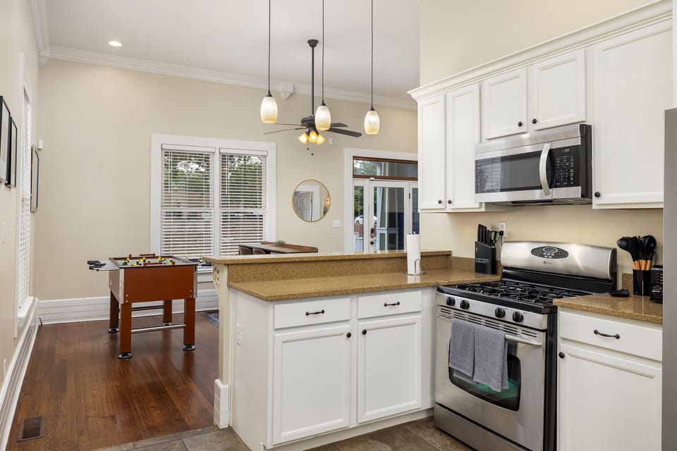 Step into the spacious family room, thoughtfully designed right next to the kitchen for effortless entertaining. Plus, enjoy some friendly competition with a foosball table for added fun.