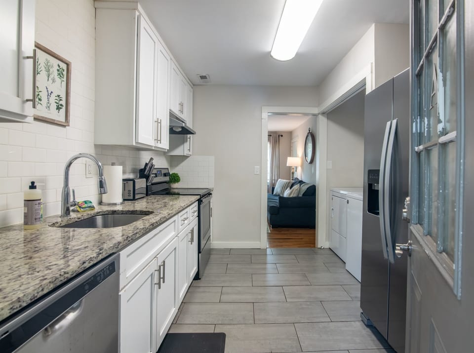 Modern galley kitchen with sleek countertops, full-size appliances, and a clean, practical layout