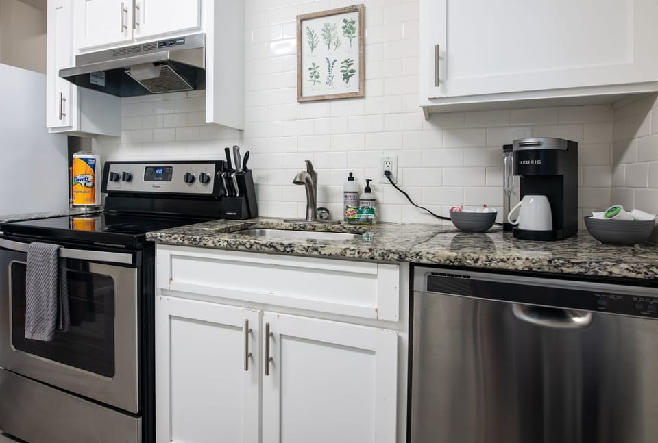 White cabinetry and clean design in the kitchen create a fresh, modern feel.