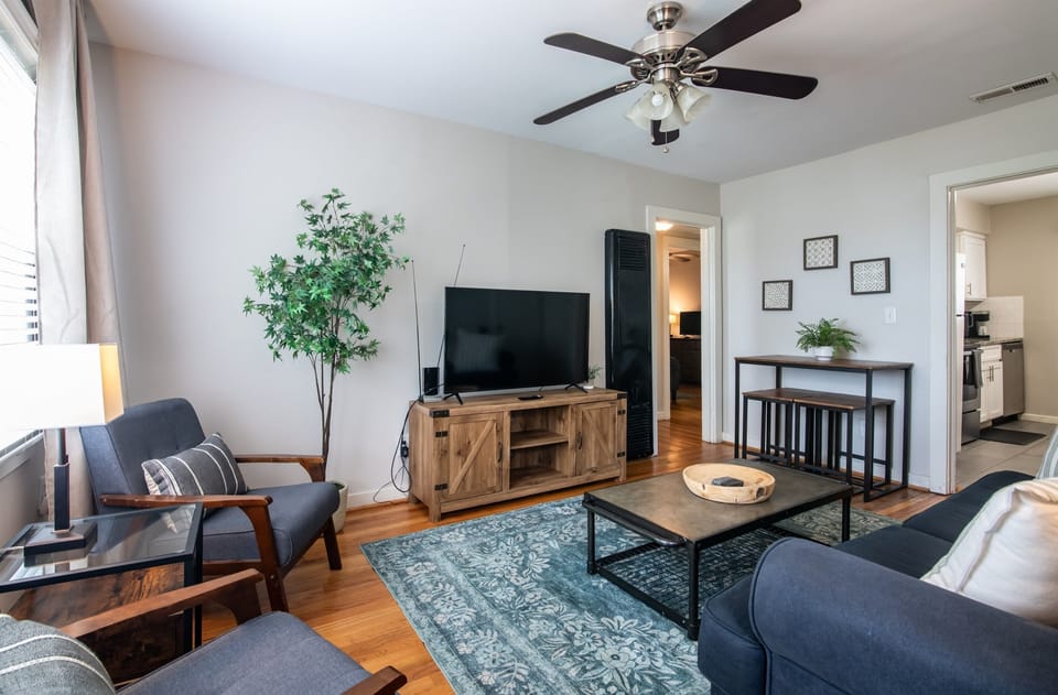 Alternate view of the bright living room with open layout and thoughtful decor touches.