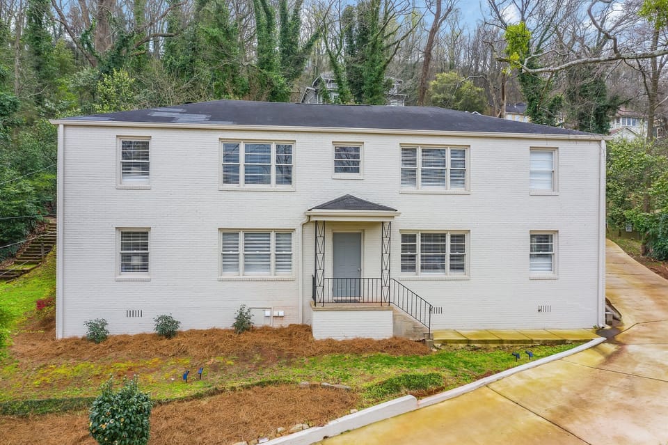 Charming and modern, the freshly painted white brick exterior of Vulcan View Suites is nestled in a serene, tree-lined neighborhood. The building's clean lines and landscaped surroundings create a welcoming first impression.
