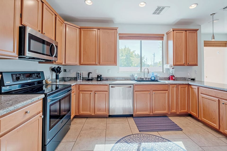 Bright U-shaped kitchen with stainless appliances and ample counter space