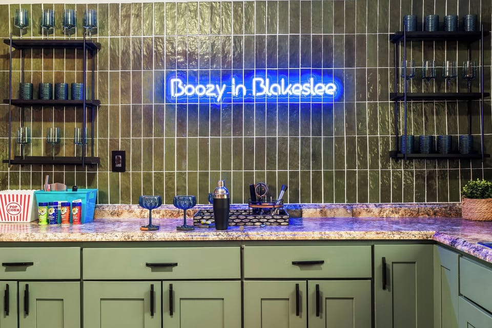 Large indoor bar with cocktail kit and glasses.  Additional fridge and sink.