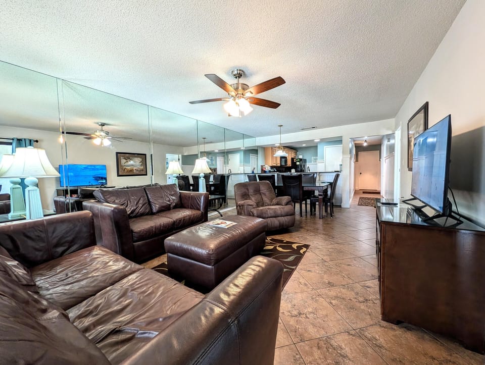Spacious living room with cozy leather seating and open layout