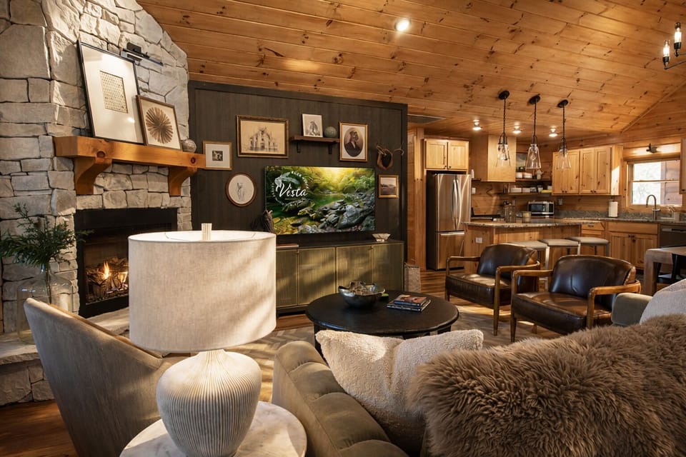 Warm wood, plush seating, and an open layout make this gathering space ideal for both lively evenings and quiet afternoons.