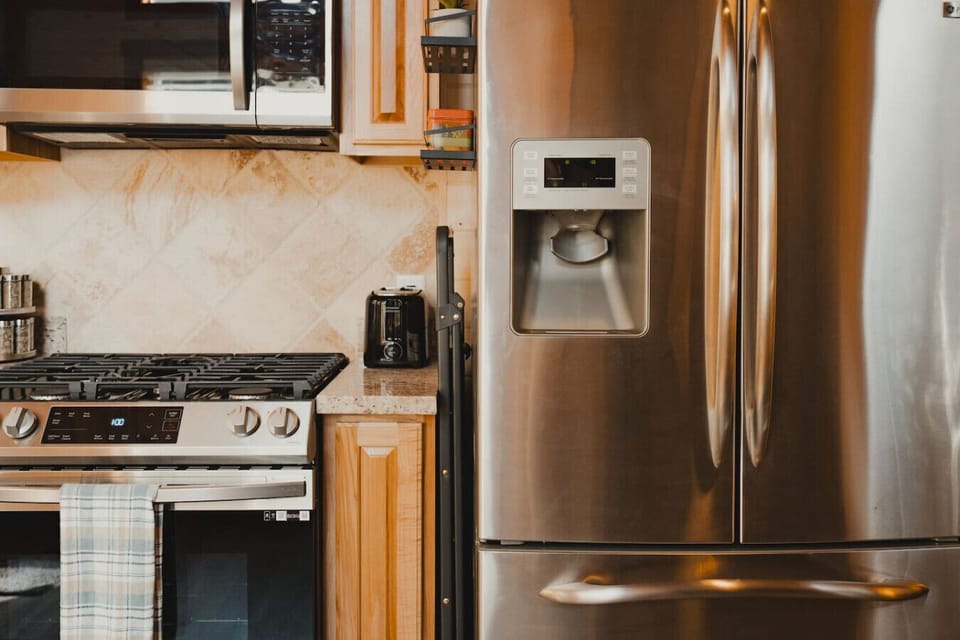 Well-Stocked Kitchen Essentials – A stainless-steel microwave, gas stove, fridge/freezer, a toaster, spice rack, olive oil & vinegar make meal prep a breeze. Plus, a step ladder is provided for easy access to high cabinets!