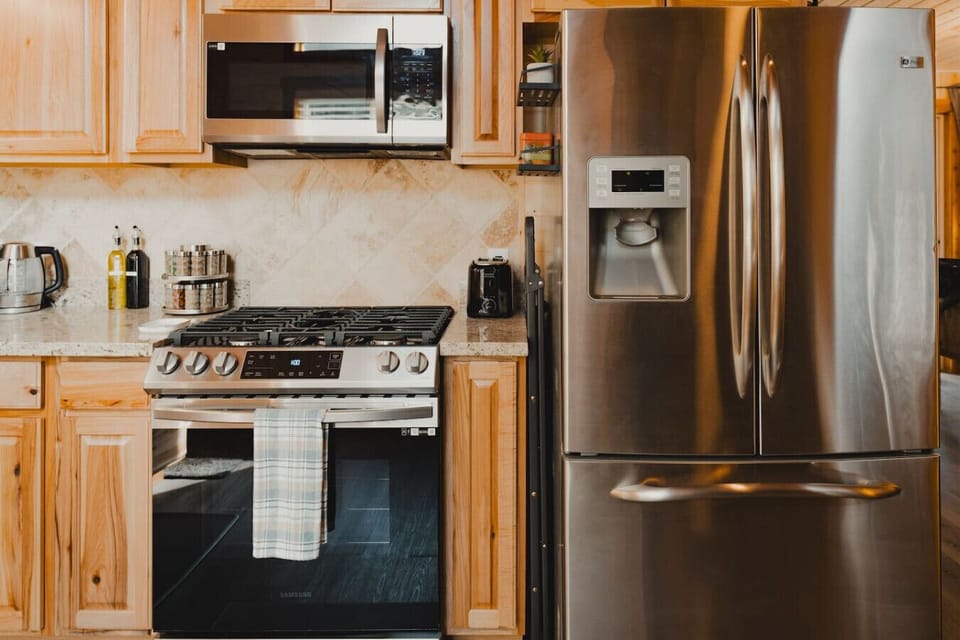 Well-Stocked Kitchen Essentials – A stainless-steel microwave, gas stove, fridge/freezer, a toaster, spice rack, olive oil & vinegar make meal prep a breeze. Plus, a step ladder is provided for easy access to high cabinets!