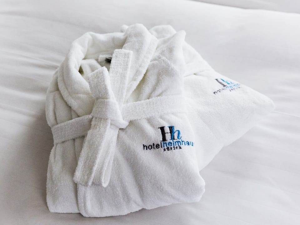 Designer toiletries, hair dryer, slippers, towels