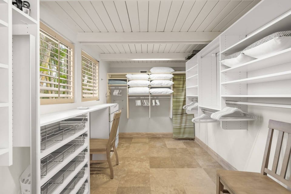 Large walk in closet with a folding table and plenty of hanging space