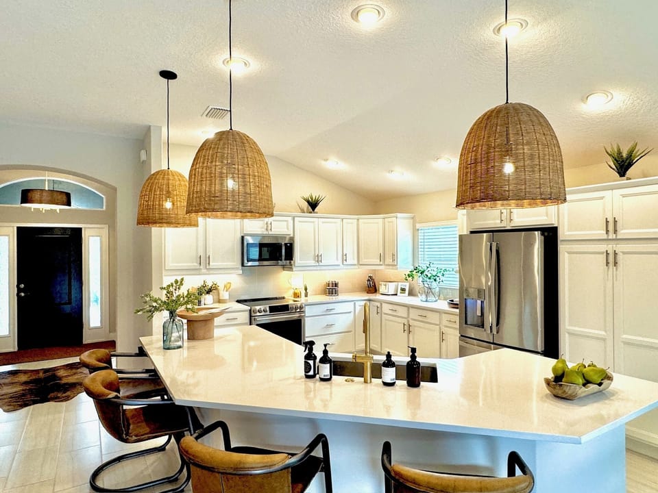 4 rich leather barstools provide additional comfortable seating around the large island.