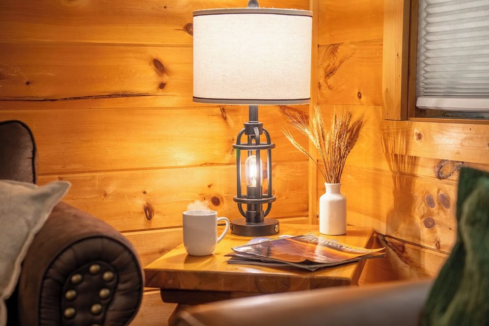 Curl up with your favorite magazine beside this charming rustic bedside table, where warm wood tones and soft lamplight create your perfect cozy corner.
