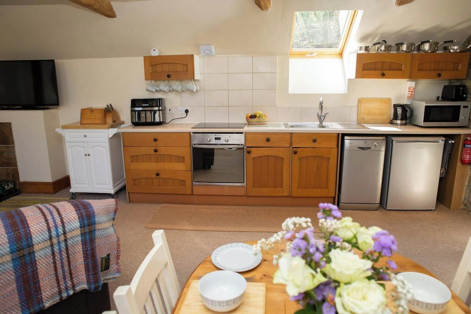 Kitchen area with microwave, dishwasher, and electric oven