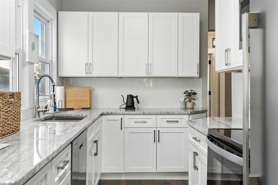 Kitchen fully stocked with spices, seasonings, condiments.