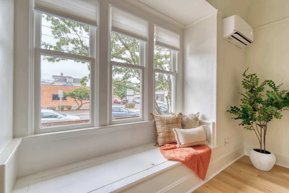 Built-in bench beneath large windows.