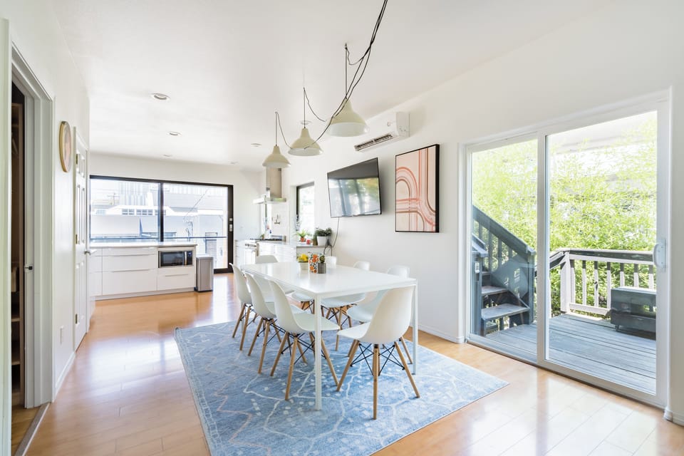 Dining area beside glass doors to an outdoor deck.
