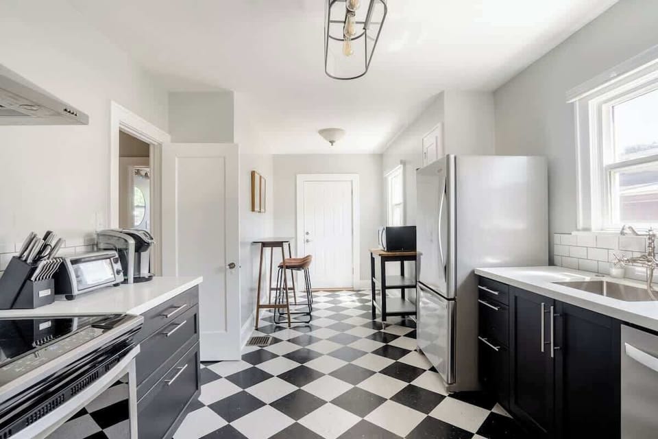Main kitchen with stove and breakfast seating.