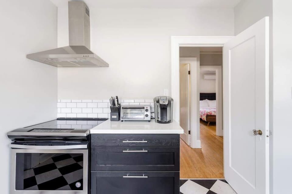 Main kitchen with range and open shelving.